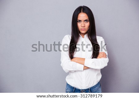 https://thumb7.shutterstock.com/display_pic_with_logo/580987/312789179/stock-photo-portrait-of-angry-woman-standing-with-arms-folded-on-gray-background-312789179.jpg
