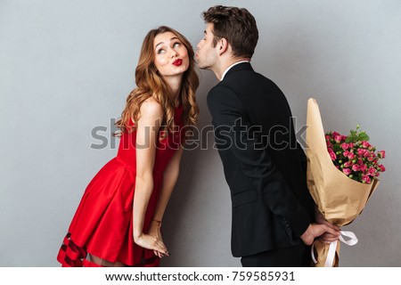 [fb] les angélus // jola&monsiame Stock-photo-portrait-of-a-young-lovely-couple-kissing-while-standing-and-holding-flower-bouquet-over-gray-wall-759585931