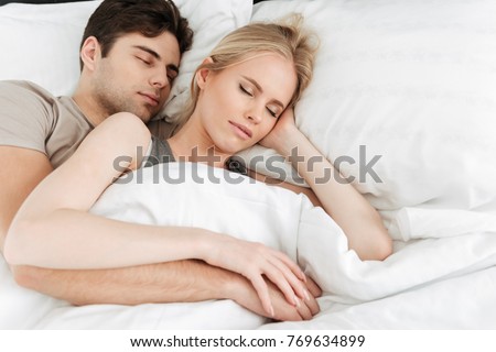 https://thumb7.shutterstock.com/display_pic_with_logo/580987/769634899/stock-photo-portrait-of-calm-handsome-lovers-young-man-and-woman-sleeping-in-white-soft-bed-and-hugging-in-769634899.jpg