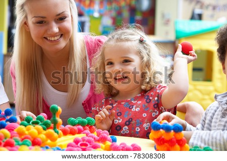 Young woman playing with girl