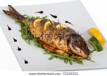 fried fish with fresh herbs and lemon - stock photo