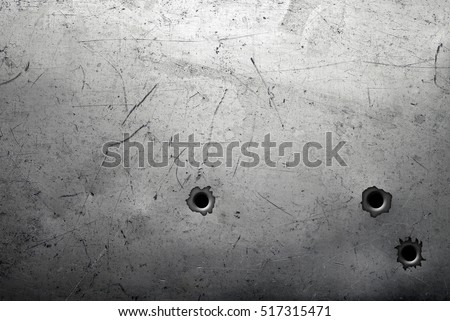Worn metal background with bullet holes