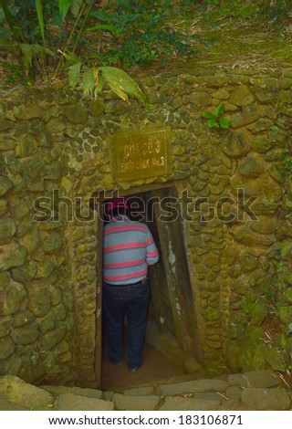 QUANG TRI, VIETNAM - MARCH 13 : Tourist walks into Vinh Moc underground tunnel used during B52 carpet bombing between Vietnam war on March 13, 2014 in Quang Tri, Vietnam.