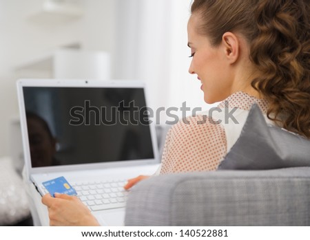 happy young housewife laptop credit card stock photo royalty free