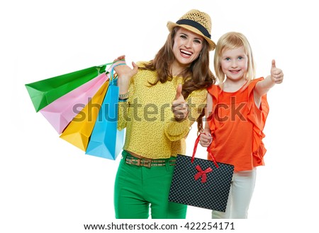 Colourful vibes of family shopping. Portrait of happy mother and daughter with shopping bags on white background showing thumbs up