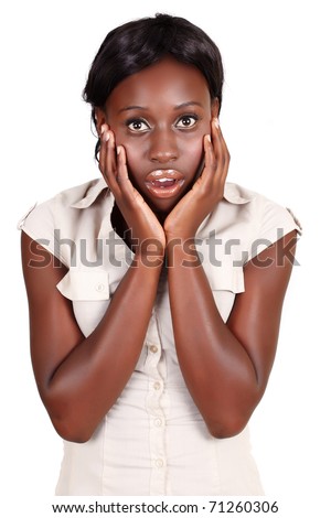 young African American businesswoman holding her face in the hands with open mouth in shock, isolated on white.