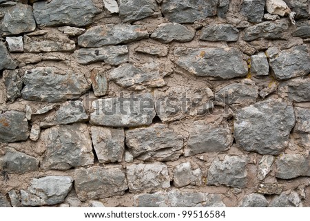 Old Stone Wall At The Foot Of A Medieval Castle Old Stone Wall At The Foot Of A Medieval Castle