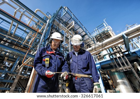 two oil and gas workers with main station at refinery industry