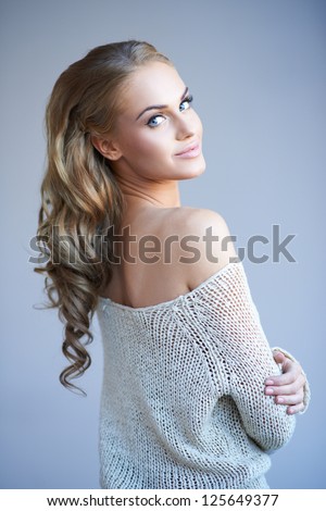 https://thumb7.shutterstock.com/display_pic_with_logo/61004/125649377/stock-photo-beautiful-elegant-woman-with-long-curly-blonde-hair-wearing-a-stylish-off-the-shoulder-top-looking-125649377.jpg
