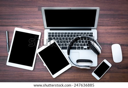 laptop with tablet and smart phone on table