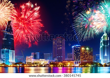 Celebration. Skyline with fireworks light up sky over business district in Ho Chi Minh City ( Saigon ), Vietnam. Beautiful night view cityscape. Holidays, celebrating New Year.