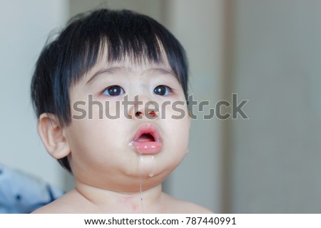 Asian baby drooling isolated on white background.