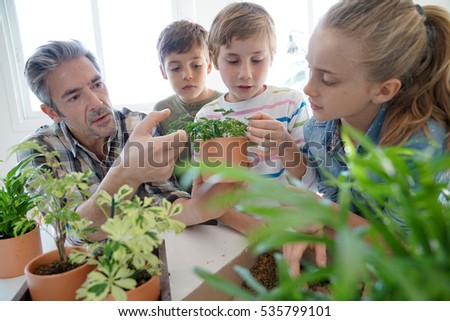 Teacher with kids in biology class learning about plants