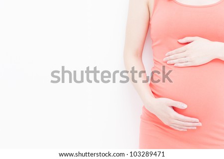 pregnant woman touching her belly