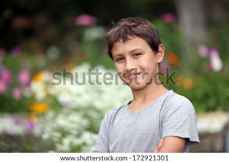 boy 10 years old against summer flower