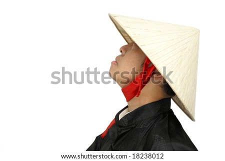 Asian man with conical hat looking upwards sideview