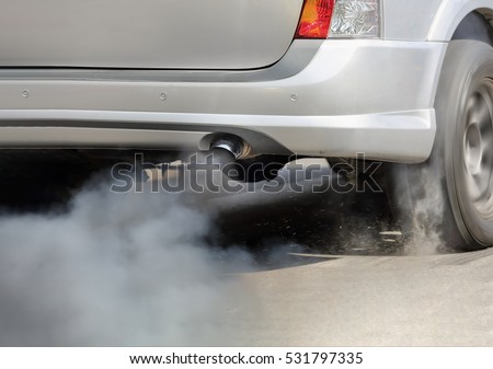 Air pollution from vehicle exhaust pipe on road