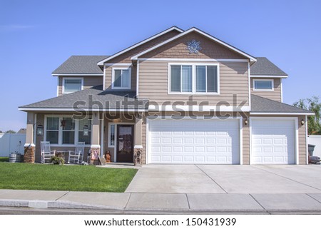  Suburban  Home  Beige  Siding Double Garage Stock Photo 