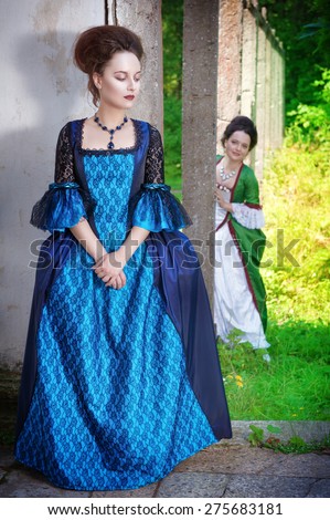 https://thumb7.shutterstock.com/display_pic_with_logo/649624/275683181/stock-photo-two-young-beautiful-women-in-long-medieval-dresses-outdoor-275683181.jpg
