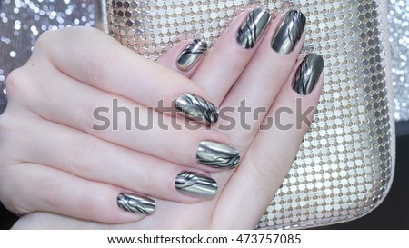Metallic Nail design . Manicure nail paint . beautiful female hand with colorful nail art design manicure