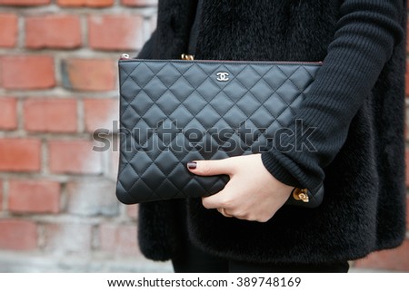 MILAN - FEBRUARY 25: Woman poses for photographers with black leather Chanel bag before Fendi fashion show, Milan Fashion Week Day 2 street style on February 25, 2016 in Milan.