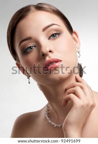 http://thumb7.shutterstock.com/display_pic_with_logo/663268/663268,1326292332,5/stock-photo-portrait-of-beautiful-woman-with-beautiful-make-up-and-hairstyle-elegant-woman-with-pearl-jewelry-92491699.jpg