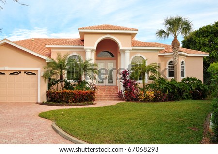 Stucco House Stock Images, Royalty-Free Images & Vectors ...  Elegant home, with huge archway covering double door entrance, flanking  columns, lush tropical