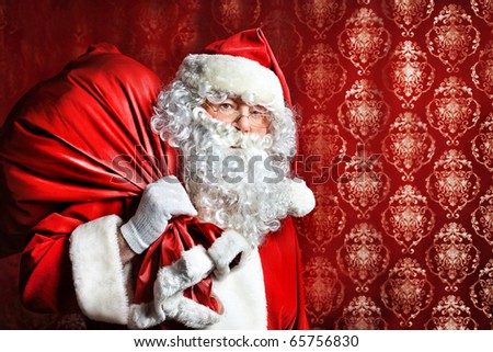 Portrait of Santa Claus with a bag of presents. Christmas.