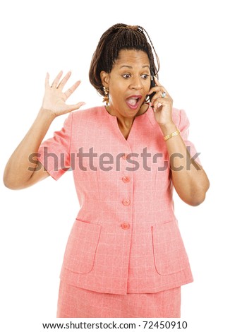 Beautiful african american woman gets exciting news over her mobile phone.  Isolated on white.