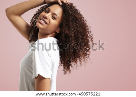 happy smiling woman touching her curly hair