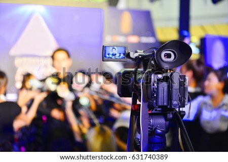 Photographer video recording activity, Lots of television cameras in a row broadcasting a live media event.