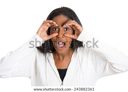 Closeup portrait headshot young, middle aged curious surprised shocked woman peeking, through fingers like binoculars searching something looking into future isolated white background. Face expression