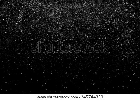 Freeze motion of white powder coming down, isolated on black, dark background. Abstract design of falling dust cloud. Particles cloud screen saver, wallpaper with copy space. Rain, snow fall concept