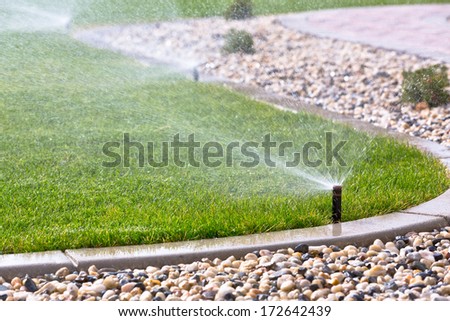 watering lawn with sprinklers