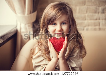 Valentine's Day - dreaming cute child with red Heart in hands. Series of photos