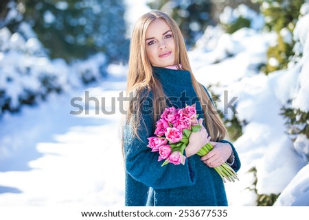 https://thumb7.shutterstock.com/display_pic_with_logo/701650/253677535/stock-photo-young-woman-with-a-bouquet-of-tulips-at-the-park-snow-in-early-spring-253677535.jpg