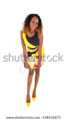 https://thumb7.shutterstock.com/display_pic_with_logo/70209/538436875/stock-photo-a-beautiful-african-american-slim-woman-standing-in-a-black-and-yellow-dress-with-her-purse-in-her-538436875.jpg