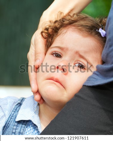 Portrait of a two year old little girl upset and crying.