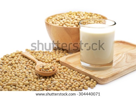 Isolated soy beans and soy milk in a glass on wooden tray