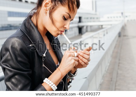 https://thumb7.shutterstock.com/display_pic_with_logo/719740/451490377/stock-photo-outdoors-lifestyle-portrait-of-young-woman-smoking-a-cigarette-451490377.jpg