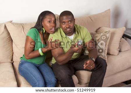 https://thumb7.shutterstock.com/display_pic_with_logo/72292/72292,1271651105,1/stock-photo-young-african-american-couple-sitting-in-living-room-on-couch-watching-tv-together-51249919.jpg
