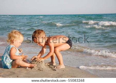 two kids playing on beach