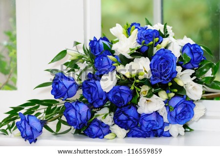 Brides bouquet of blue and white roses - stock photo