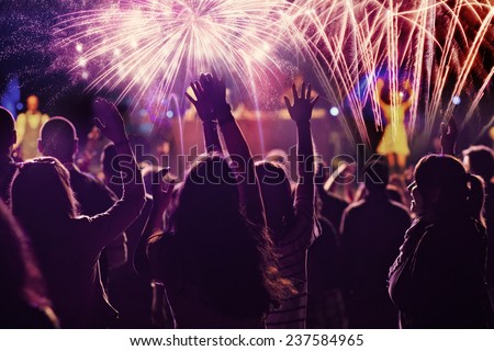 New Year concept - cheering crowd and fireworks