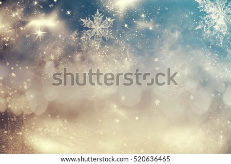 Magic blue holiday abstract glitter background with blinking stars and falling snowflakes. Blurred bokeh of Christmas lights.