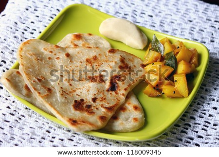 Indian Bengali breakfast plate with paratha, potato sabzi and sweet - stock photo