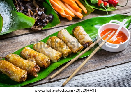 Fried spring rolls surrounded by ingredients