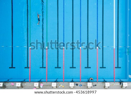 top view bird eye view of blue swimming pool with swimmers and starting platforms - Olympic Swimming Pool Top View top view bird eye view of blue swimming pool with swimmers and starting platforms - Olympic Swimming Pool Top View