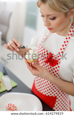 pretty young woman decorating cupcakes on her kitchen portrait of a beautiful female business owner - Woman Decorating Cupcakes pretty young woman decorating cupcakes on her kitchen portrait of a beautiful female business owner - Woman Decorating Cupcakes