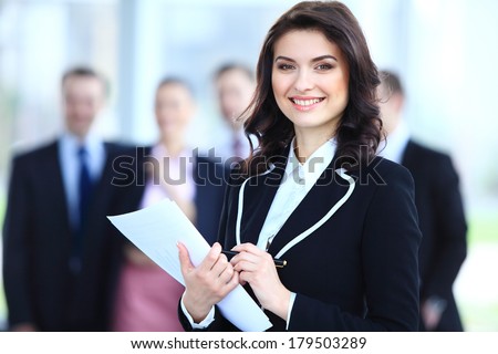 Face of beautiful woman on the background of business people